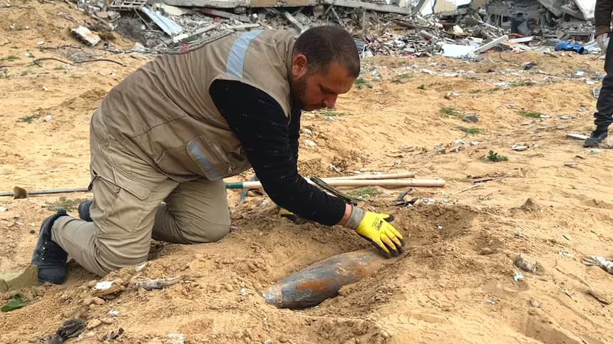 Un hombre palestino desentierra un obus israelí en Rafah. Foto: Mohamed El Saife/CBC