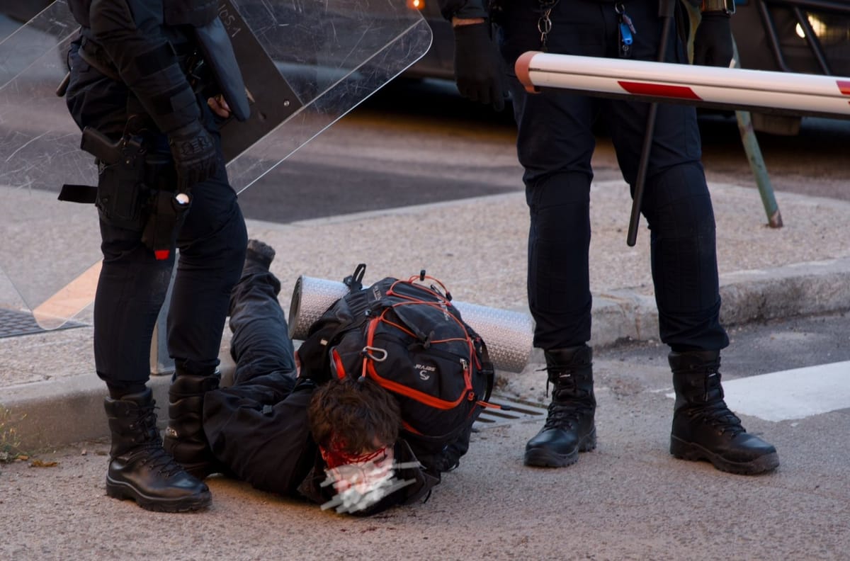 Un detenido con la cabeza abierta a los pies de la Policía en la huelga de profesorado en Madrid. Foto: vía @UCMporlaPublica (X)